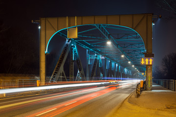 Moving car with blur light through Pilsudski Bridge at night in Torun. Poland. Europe. © vivoo