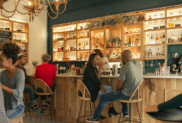 Young African American couple having drinks together in a bar