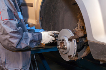 The man is repairing the disc brake