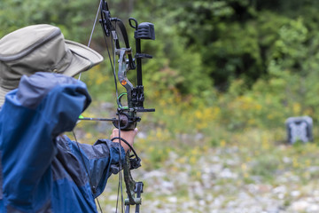 A Man Shooting a Compound Bow 