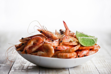 Big boiled shrimps in white plate close up. Seafood concept. Food photography