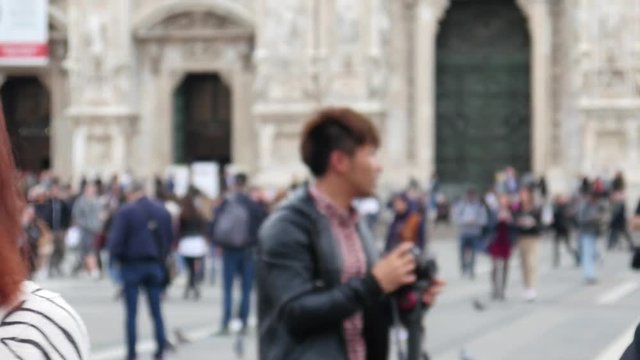 Wedding guest take phone photo of walking newlyweds for social media in Milan