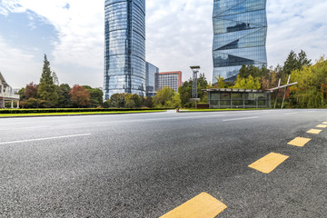 Naklejka premium Modern business office buildings with empty road,empty concrete square floor