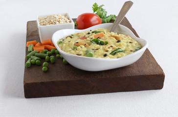Oats pongal, an healthy, Indian vegetarian food, is made from ingredients like oats, and long green beans, and is said to prevent or control cholesterol and give other health benefits.