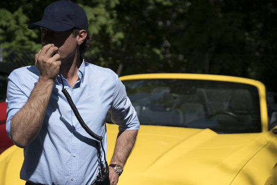 Man speaking on radio set outside