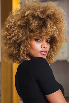 Ethnic woman in bodysuit at home