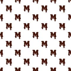 Letter M from latin alphabet with numbers and symbols made of dark melted chocolate