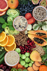 High fibre health food concept with cereals, whole wheat pasta, fruit, vegetables, legumes and cereals. Foods high in smart carbohydrates, antioxidants, anthocynins and vitamins. Top view.