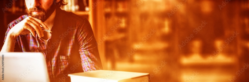Poster student studying in library at university