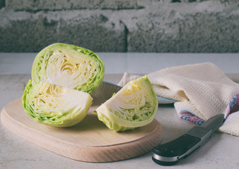 Chopped cabbage on a wooden cutting board. Sliced cabbages in minimalist style. Prepare to cook,...