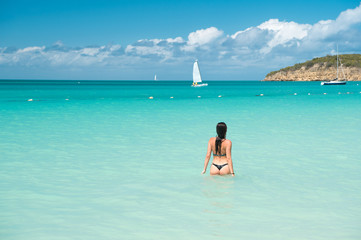 Girl swimwear azure crystal ocean water rear view. Vacation luxury ocean beach resort. Swim through magical turquoise lagoon. Woman sexy body relaxing ocean beach Antigua. Enjoy paradise