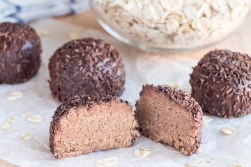 Swedish sweets Arrack balls, made from cookie crumbs, cocoa, butter and coconut wine Arrack flavour, on wooden table, horizontal