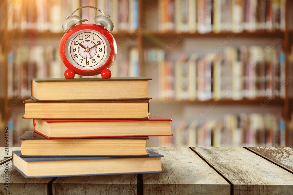 Poster composite image of old alarm clock and stack of books