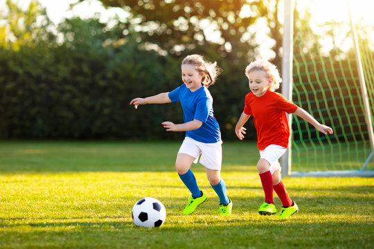 Kids Play Football. Child At Soccer Field.