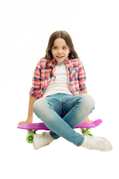 Sit and relax. Kid girl relaxed sits penny board. Learning how to ride penny board. Modern teen hobby. Girl happy face sit on penny board white background. Originally designed as girls skateboard