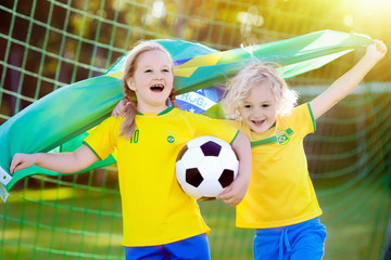 Brazil football fan kids. Children play soccer.