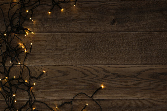 Christmas Light or Garland Lights on Wood Background