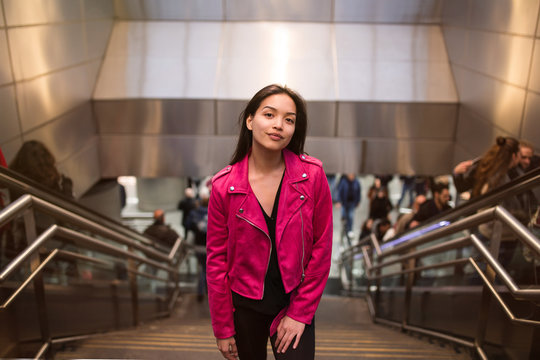 Charming young woman on stairs in subway