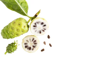 Poster Noni fruit or Morinda Citrifolia and noni slice with seed and green leaves of the noni isolated on white blackground with copy space for text. Top view. © nicemyphoto