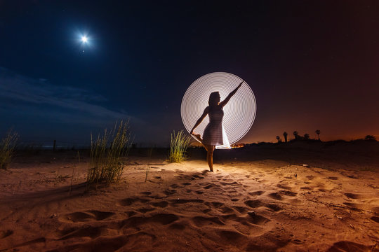 Silhouette of woman with colored lights