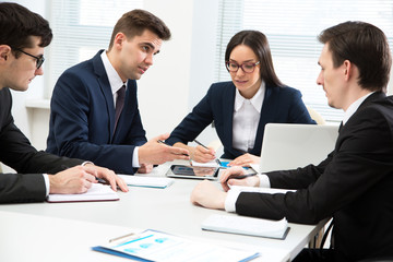 Businessman explains to colleagues a new project
