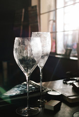 Wine glasses with fingerprints in bright morning light