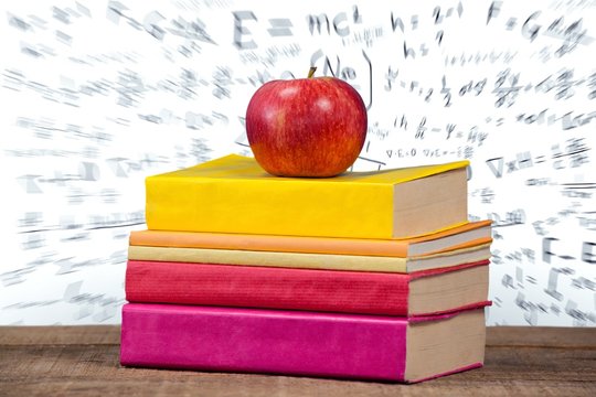 Apple with books on table