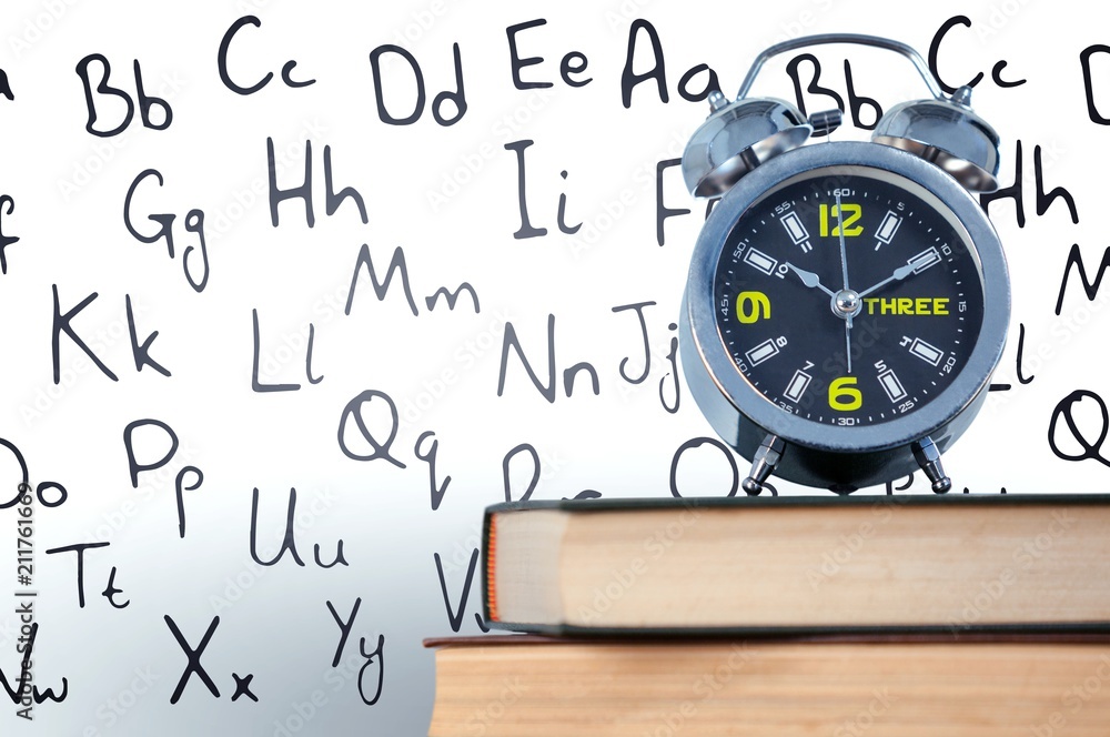 Poster alarm clock placed on stack of books
