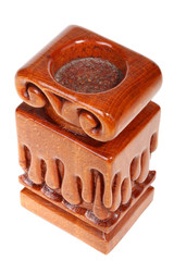 Single old brown wooden candlestick without candle with carved droplets in form of melted wax. Isolated on a white