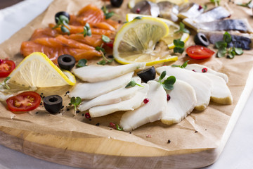 Different types of fish herring, salmon on wooden Board