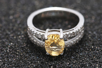 Yellow gem stone on diamond ring