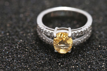 Yellow gem stone on diamond ring