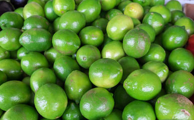 New harvest green lemons for sale at city market