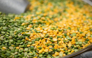 Macroshot of green and yellow mixed lentils, sale on local city market