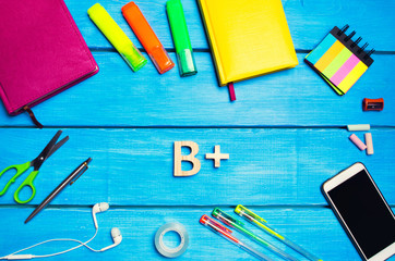 school supplies in the school desk, stationery, school concept, blue background, creative chaos,...