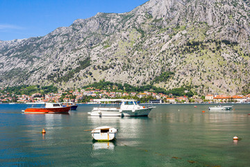 Nature landscape in boka-kotor bay with boats in the water, old european city Kotor surrounded...