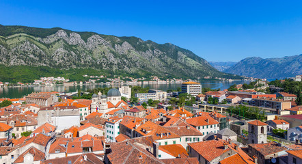 Naklejka na ściany i meble Panoramic view from above on the old historical city Kotor with orange tile roofs, boka-kotor bay and mountains at Adriatic sea coastline, Montenegro