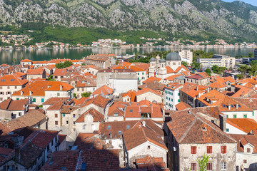 View from above on the old historical city Kotor with orange tile roofs, boka-kotor bay and...
