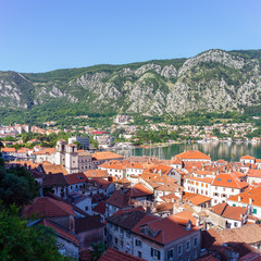 View from above on the old historical city Kotor with orange tile roofs, boka-kotor bay and...