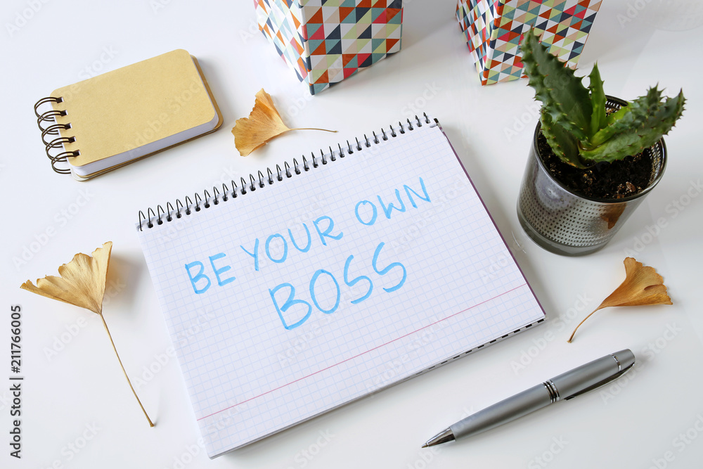 Poster be your own boss written in a notebook on white table