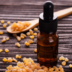 frankincense essential oil on a wooden background