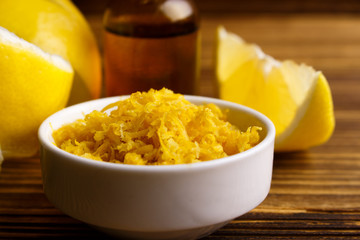 Lemon essential oil on a wooden background