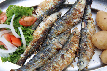 Fresh grilled Sardines with Potato and Lettuce. Portugal