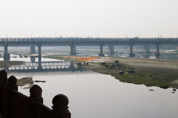 Agra, India - January 15, 2017. Indian people washing and drying cloth on the sandy banks of Yamuna river in Agra, India. Agra is a city on the banks of the river Yamuna in Uttar Pradesh.