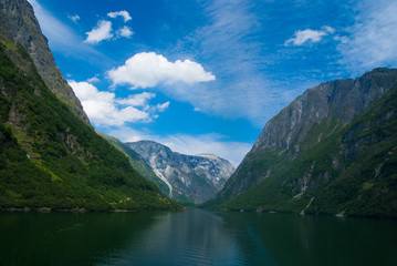 Fjord in Homersfag, United Kingdom. Sea and mountains on cloudy blue sky. Summer vacation. Discover wild nature. Wanderlust and travelling concept