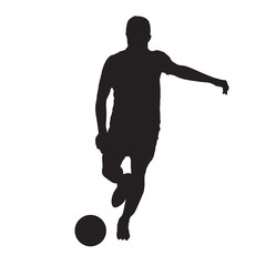 Obraz premium Soccer player kicking ball, front view. Isolated vector silhouette