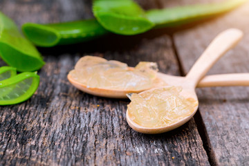 Aloe vera on wooden spoon on wooden table There are many useful herbs.