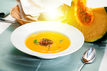 beautiful flow, pumpkin soup with fried bacon, close-up, restaurant