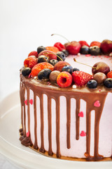 Delicious homemade cake decorated with chocolate and fresh berries