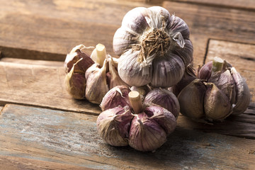 Fresh garlic on white background. Garlic cloves. Peeled garlic bulbs on jute.